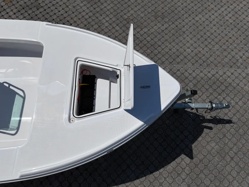 Slide: The Image of 2025 Action Craft 17 Flats boat with open storage compartment on a trailer. - 61