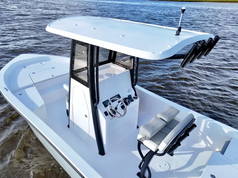 Slide: The Image of 2025 Action Craft 24 Coastal Bay boat on water, featuring sleek design and modern console. - 17