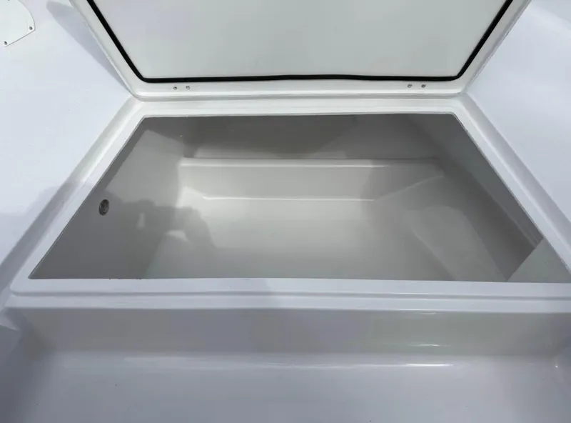 Slide: The Image of Open storage compartment on 2025 Action Craft 24 Coastal Bay boat. - 32