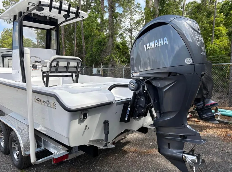 Slide: The Image of 2025 Action Craft 24 Coastal Bay boat with Yamaha outboard motor on a trailer. - 36