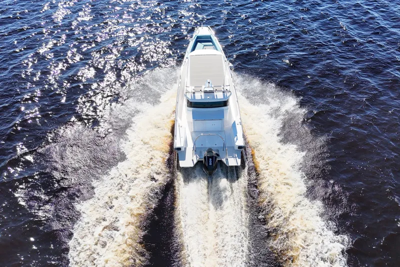 Slide: The Image of 2020 Axopar 28 CABIN boat cruising on open water, aerial view. - 31