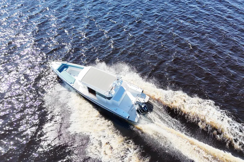 Slide: The Image of Aerial view of 2020 Axopar 28 CABIN boat cruising on open water. - 37