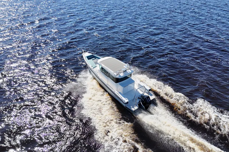 Slide: The Image of Axopar 28 CABIN 2020 cruising on open water, creating a dynamic wake. - 42