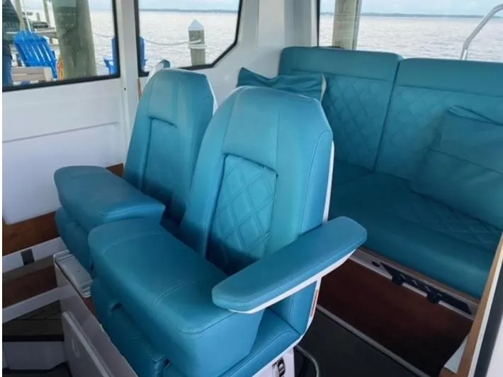 Slide: The Image of Interior of 2020 Axopar 28 boat with blue seating and armrests. - 46