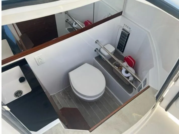 Slide: The Image of Compact bathroom in 2020 Axopar 28 boat with modern fixtures and storage. - 51