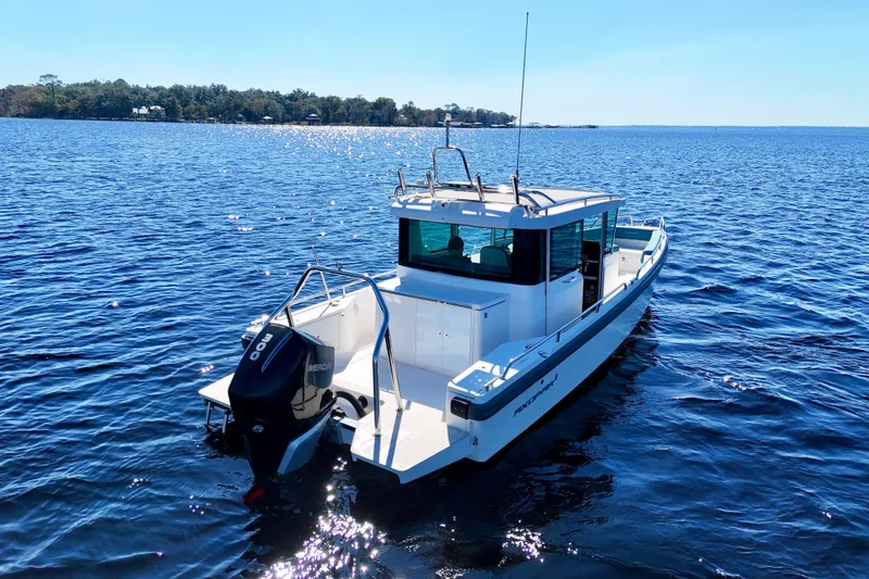 Slide: The Image of 2020 Axopar 28 CABIN boat on a sunny lake, featuring a Mercury outboard motor. - 27