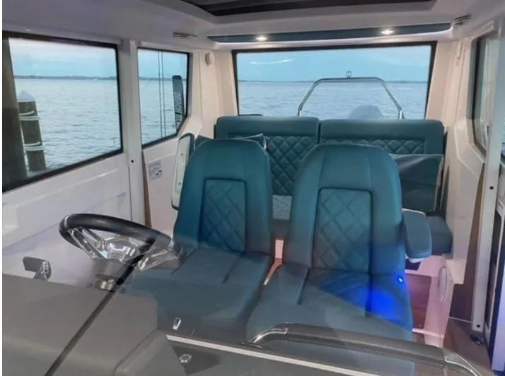 Slide: The Image of Interior of 2020 Axopar 28 boat with blue seating and ocean view. - 47