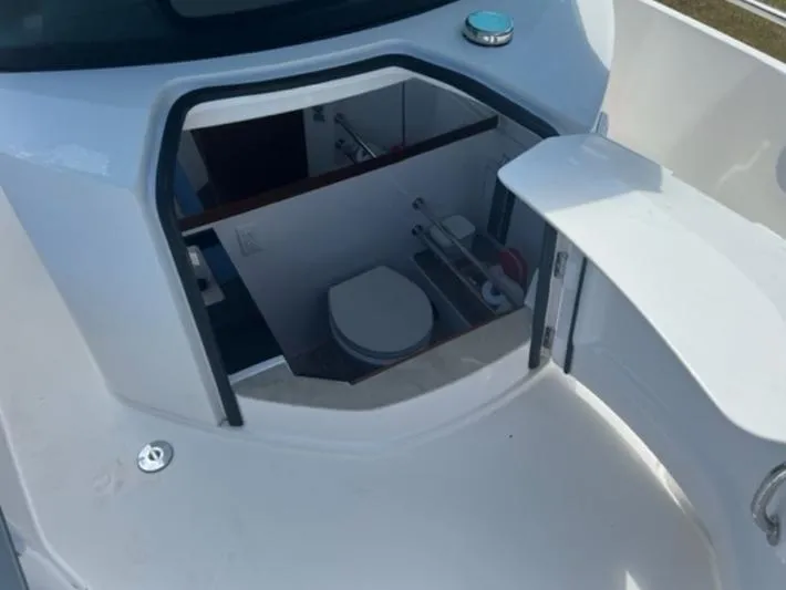 Slide: The Image of 2020 Axopar 28 boat interior with compact bathroom and toilet. - 52
