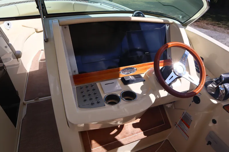 Slide: The Image of 2020 Chris-Craft Calypso 30 dashboard with steering wheel and control panel. - 21