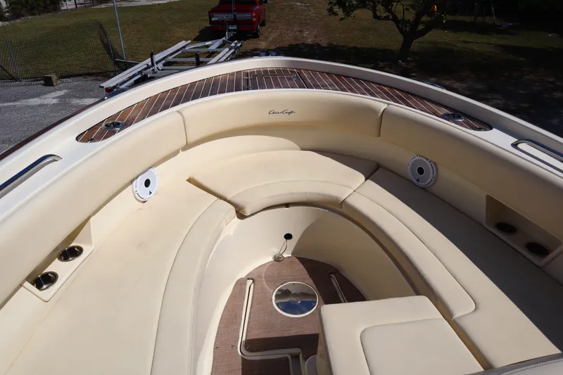 Slide: The Image of 2020 Chris-Craft Calypso 30 boat interior with cushioned seating and wood accents. - 23