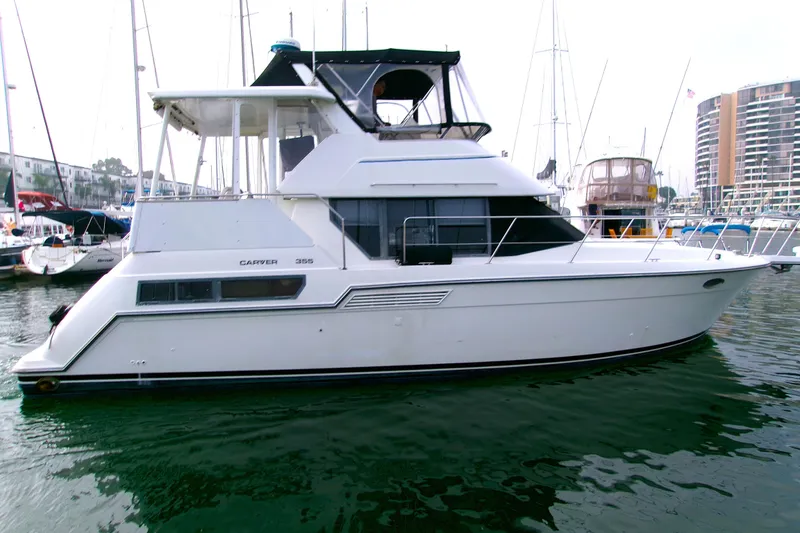 The Image of 1995 Carver 355 Aft Cabin Motor Yacht docked in marina, side view. - 0