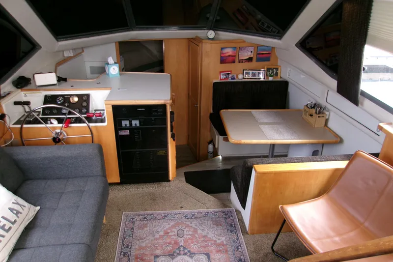 Slide: The Image of Interior of 1995 Carver 355 Aft Cabin Motor Yacht with cozy seating and helm. - 11