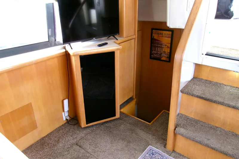 Slide: The Image of Interior of 1995 Carver 355 Aft Cabin Motor Yacht with stairs and TV. - 12