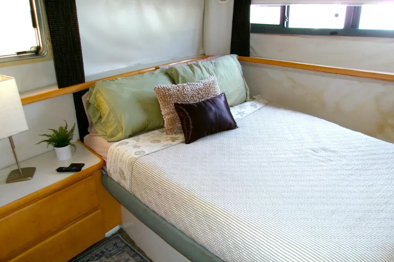 Slide: The Image of Cozy bedroom in 1995 Carver 355 Aft Cabin Motor Yacht with elegant bedding and decor. - 18
