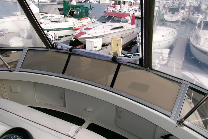 Slide: The Image of 1995 Carver 355 Aft Cabin Motor Yacht interior view at marina, surrounded by boats. - 28