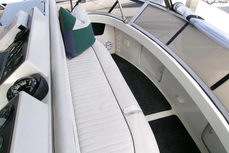 Slide: The Image of 1995 Carver 355 Aft Cabin Motor Yacht interior with white seating and navigation instruments. - 29