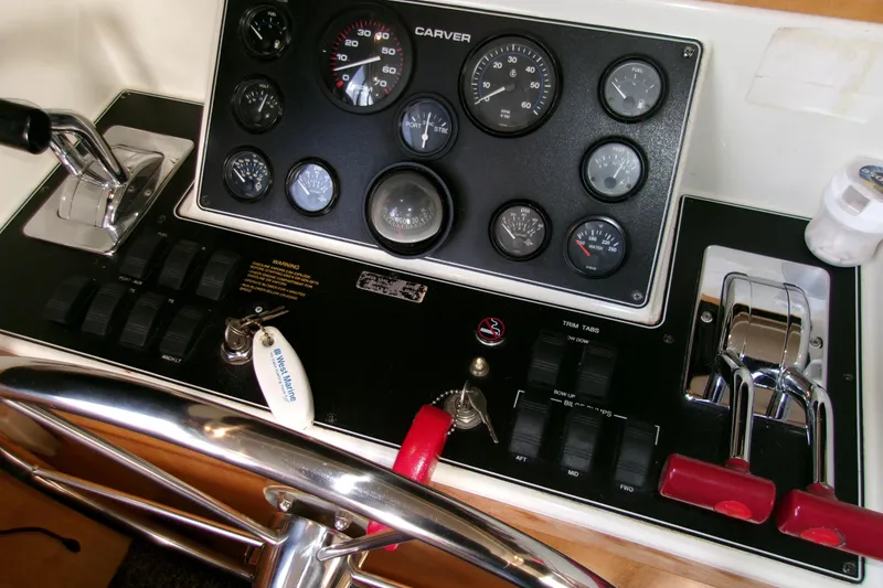 Slide: The Image of Control panel of 1995 Carver 355 Aft Cabin Motor Yacht with gauges and levers. - 31