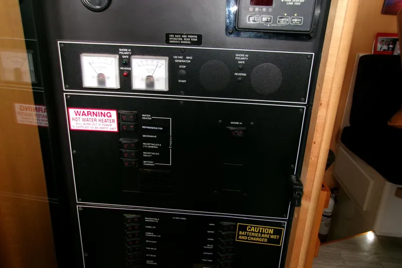Slide: The Image of Electrical panel of 1995 Carver 355 Aft Cabin Motor Yacht with warning labels. - 35