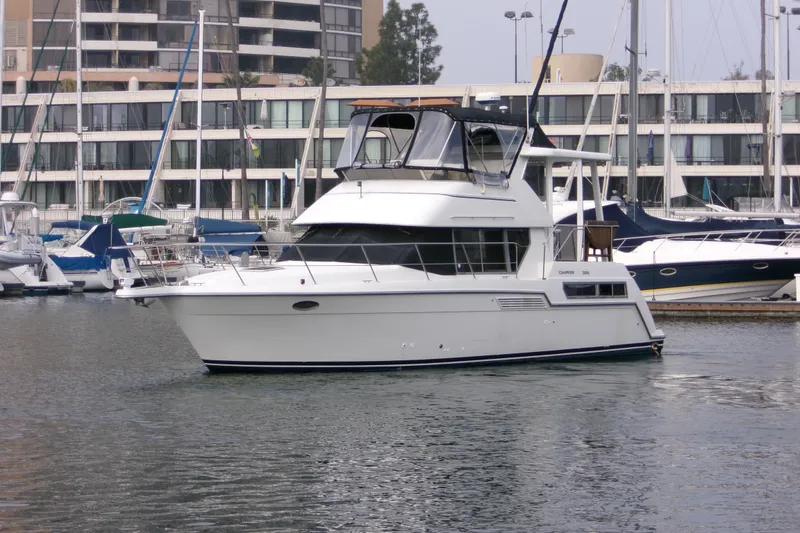 Slide: The Image of 1995 Carver 355 Aft Cabin Motor Yacht docked in marina, surrounded by other boats. - 4