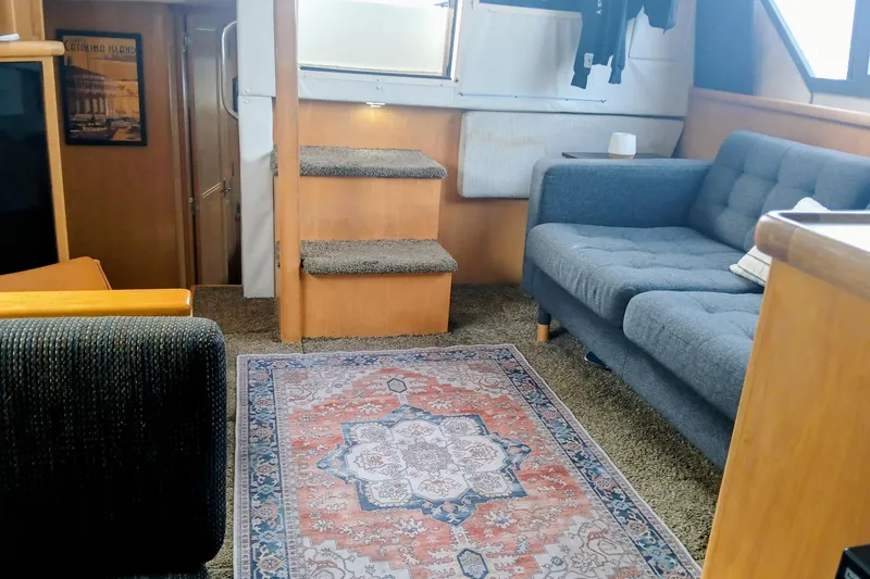 Slide: The Image of Interior of 1995 Carver 355 Aft Cabin Motor Yacht with cozy seating and decorative rug. - 9