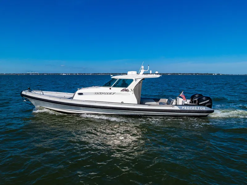 Slide: The Image of 2008 Protector 410 Targa boat on open water. - 12