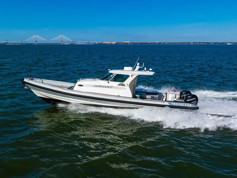 Slide: The Image of 2008 Protector 410 Targa boat on water with bridge in background. - 16