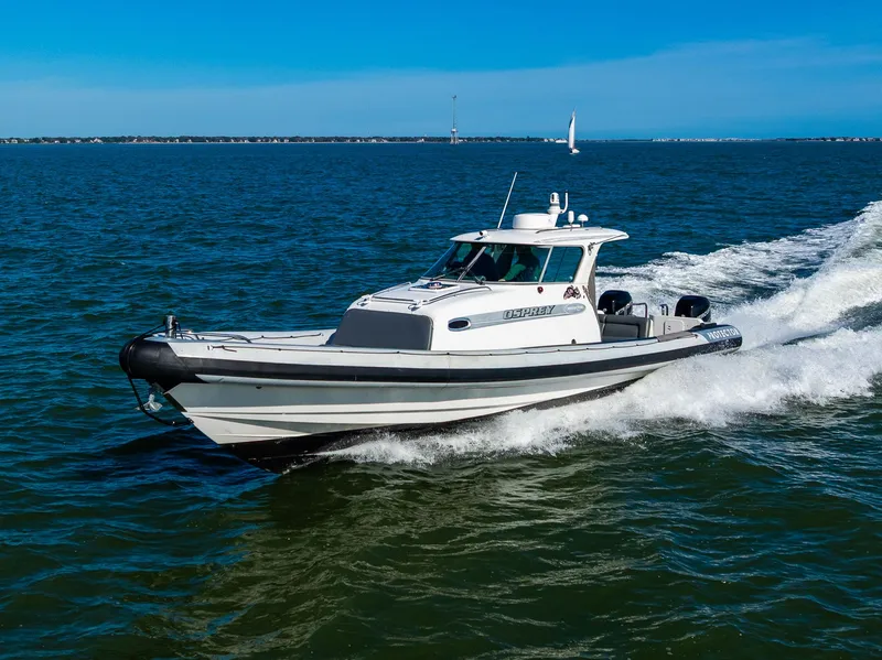 Slide: The Image of 2008 Protector 410 Targa boat cruising on water. - 17