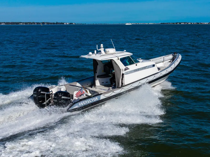 Slide: The Image of 2008 Protector 410 Targa boat cruising swiftly on the water. - 19