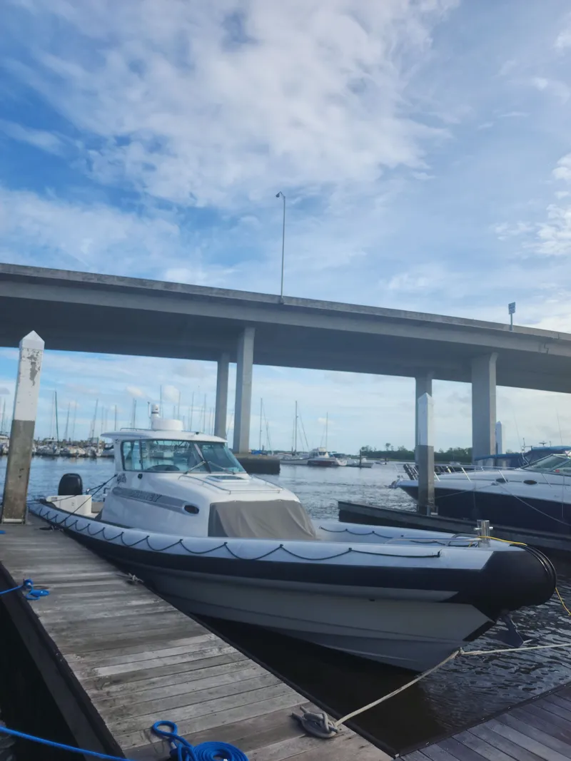 Slide: The Image of 2008 Protector 410 Targa boat docked under bridge. - 2