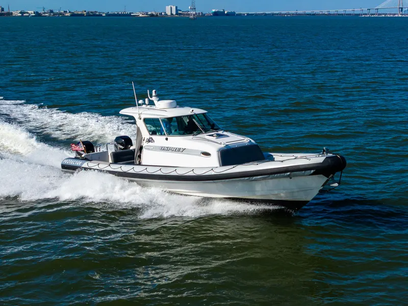 Slide: The Image of 2008 Protector 410 Targa boat cruising on open water. - 21