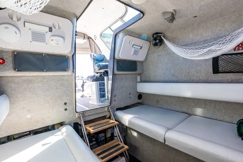 Slide: The Image of Interior of a 2008 Protector 410 Targa boat with seating area. - 26