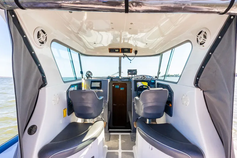 Slide: The Image of Interior of a 2008 Protector 410 Targa boat with helm console. - 42
