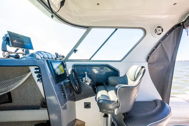 Slide: The Image of Interior of a 2008 Protector 410 Targa boat with helm console. - 44