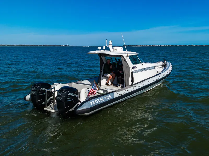 Slide: The Image of 2008 Protector 410 Targa boat on open water. - 5