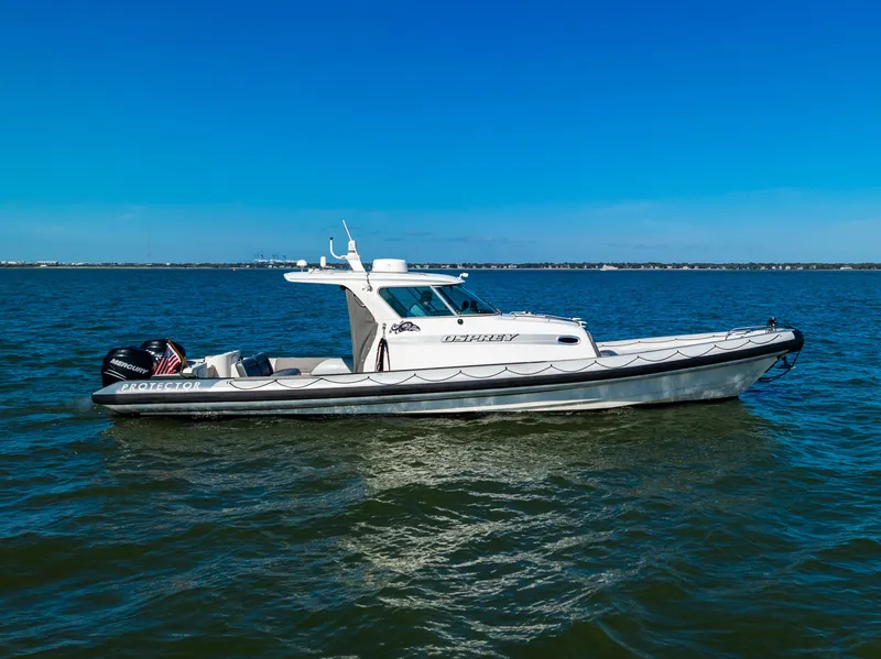 Slide: The Image of 2008 Protector 410 Targa boat on calm water. - 6