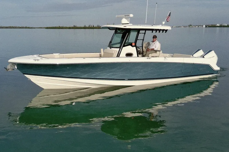 The Image of 2022 Boston Whaler 330 Outrage boat on calm water, featuring sleek design and modern amenities. - 0