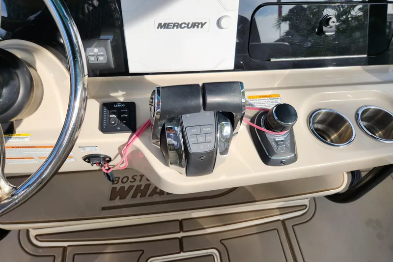Slide: The Image of Control panel of 2022 Boston Whaler 330 Outrage boat with Mercury throttle and cup holders. - 12