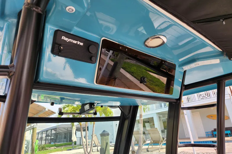 Slide: The Image of 2022 Boston Whaler 330 Outrage interior with Raymarine electronics and blue finish. - 14