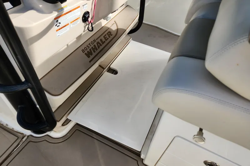 Slide: The Image of 2022 Boston Whaler 330 Outrage interior, featuring seating and deck details. - 15