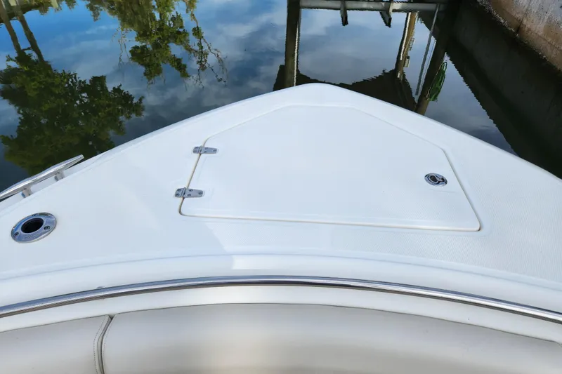 Slide: The Image of 2022 Boston Whaler 330 Outrage bow, featuring sleek design and water reflection. - 21