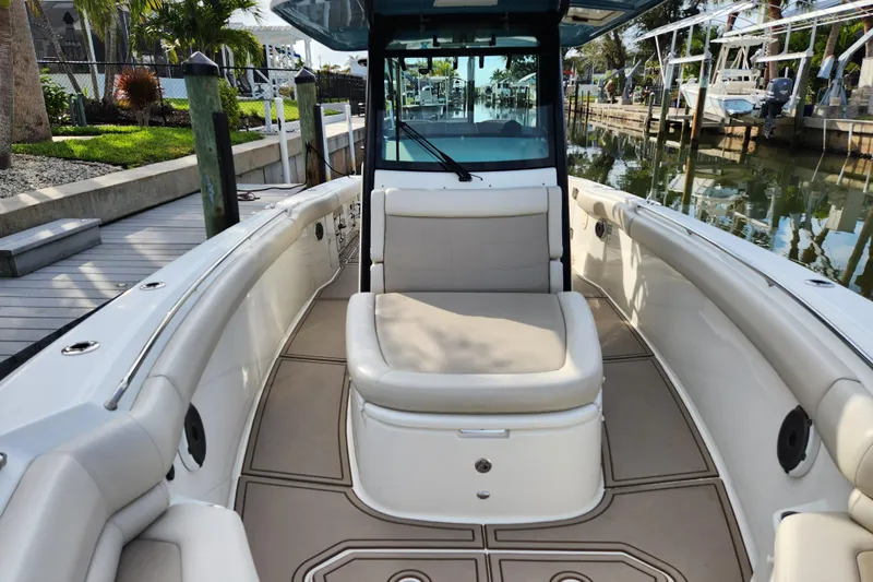 Slide: The Image of 2022 Boston Whaler 330 Outrage boat interior with seating and deck view. - 24