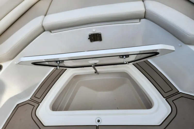 Slide: The Image of 2022 Boston Whaler 330 Outrage storage compartment with open hatch, showcasing interior space. - 29