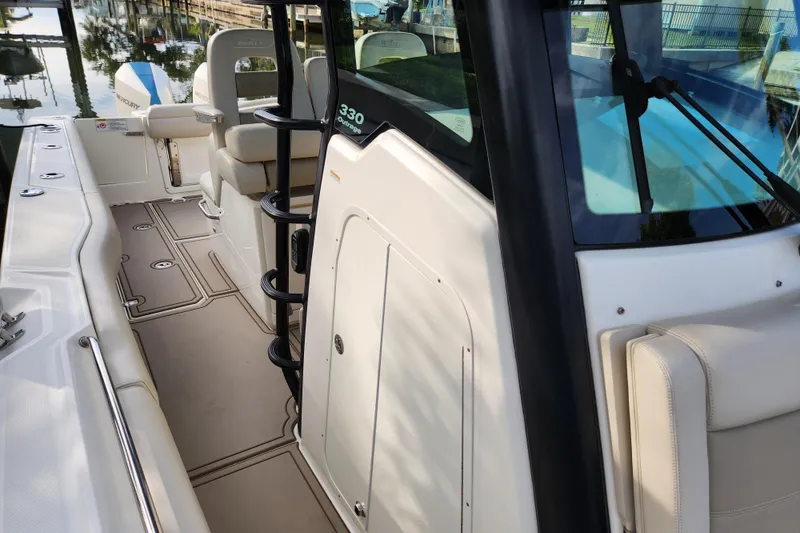 Slide: The Image of 2022 Boston Whaler 330 Outrage boat interior with seating and helm details. - 30