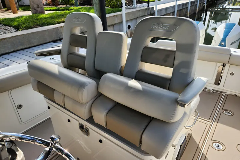 Slide: The Image of 2022 Boston Whaler 330 Outrage boat seats with gray upholstery and sleek design. - 32