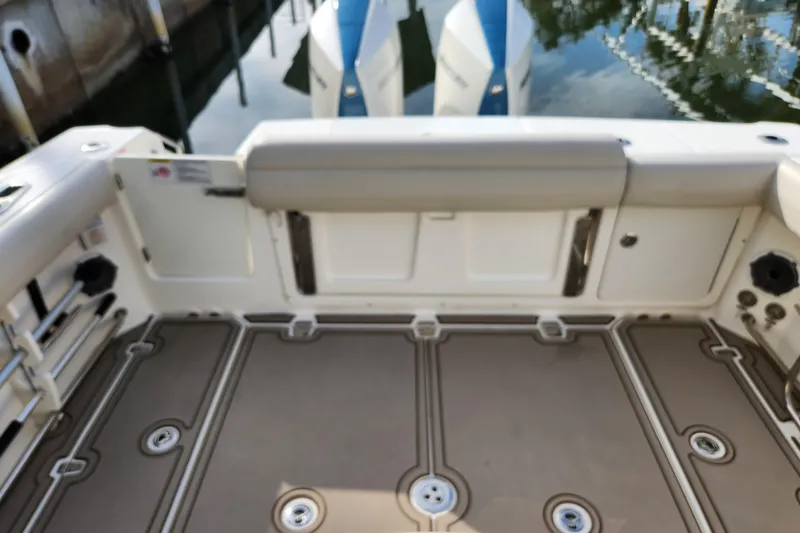 Slide: The Image of 2022 Boston Whaler 330 Outrage boat deck with seating and storage compartments. - 34