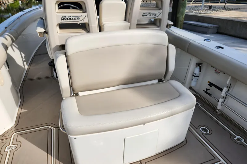 Slide: The Image of 2022 Boston Whaler 330 Outrage boat interior with beige seating and branded backrests. - 37