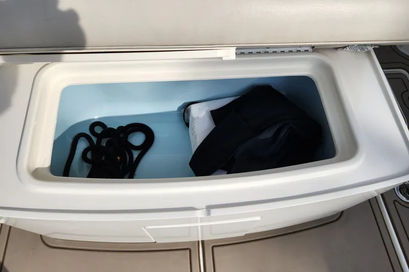 Slide: The Image of Storage compartment on a 2022 Boston Whaler 330 Outrage boat with rope and gear. - 39