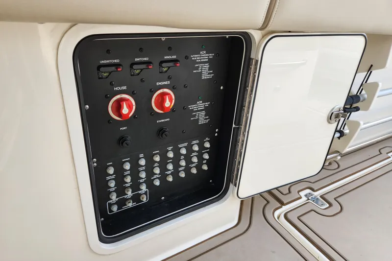 Slide: The Image of Control panel of 2022 Boston Whaler 330 Outrage boat, featuring switches and dials. - 43
