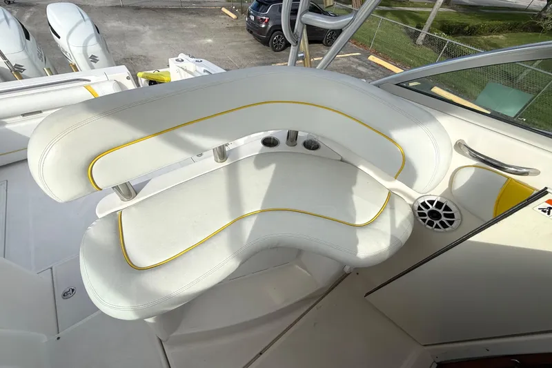Slide: The Image of 2005 Wellcraft 290 Coastal boat seating area with white and yellow upholstery. - 16