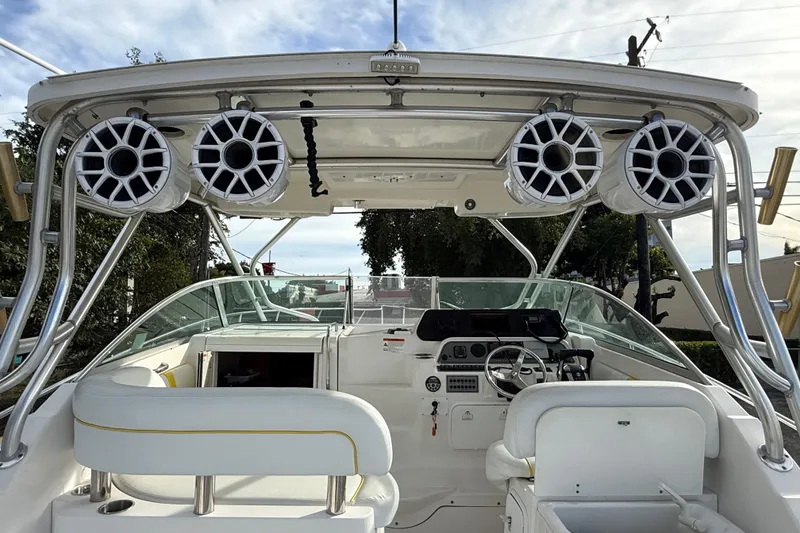 Slide: The Image of 2005 Wellcraft 290 Coastal boat interior with speakers and steering console. - 7